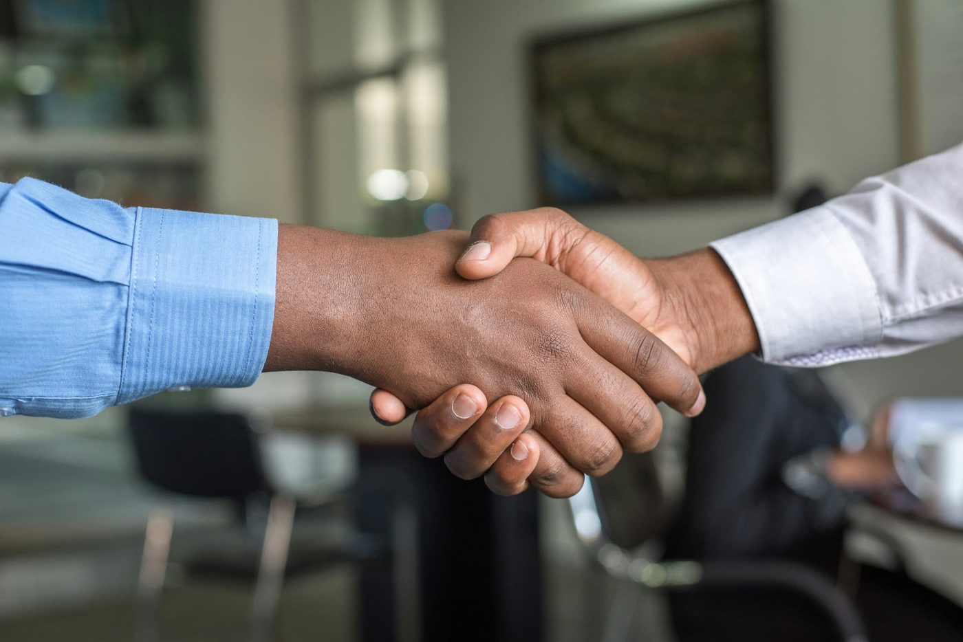 RSquared team member shaking hands with a client